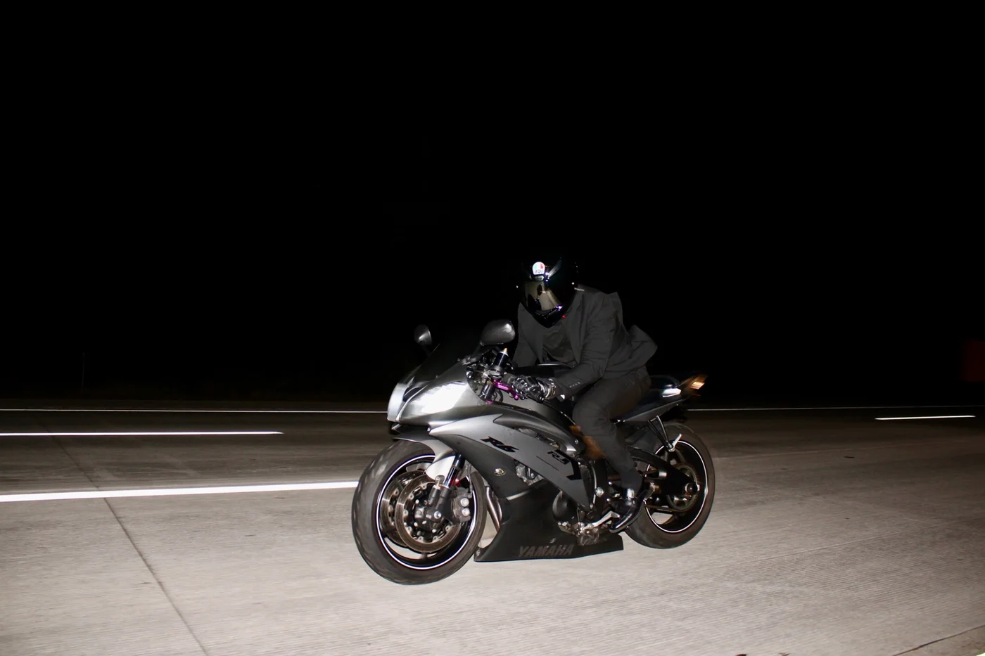 Motorcycle photographed in motion on an open road at night